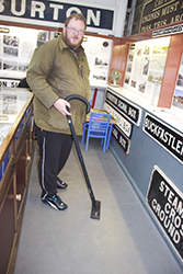 Mark wields the vacuum cleaner